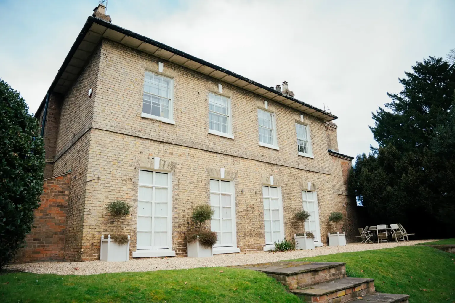 Exterior of property with tall windows and sliding sash windows made bespoke by Pelham Joinery
