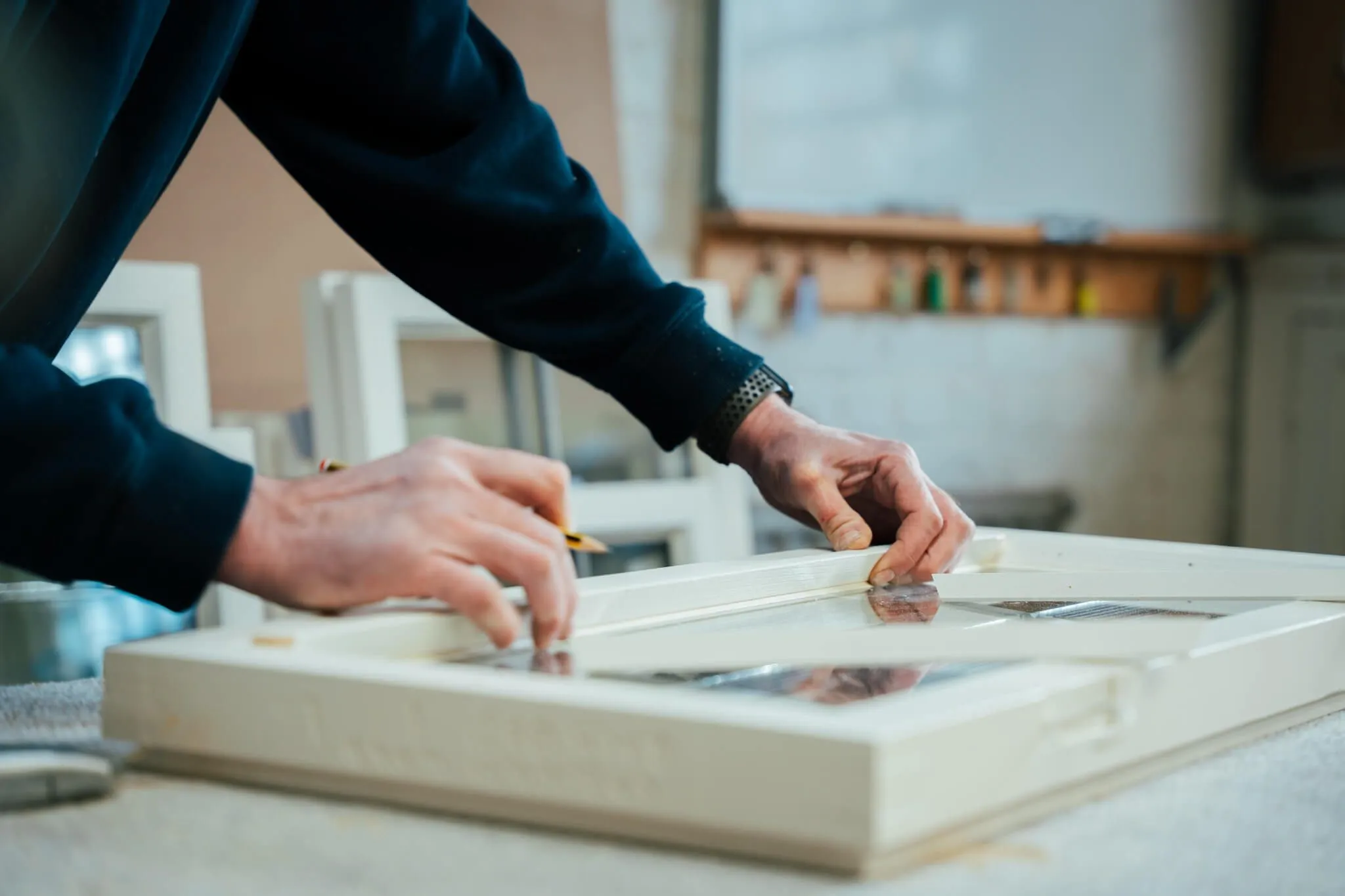 Joiner measuring and marking up an window frame