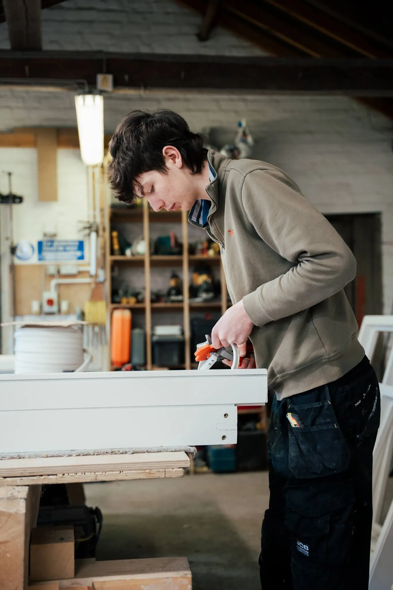 Joiner clamping sections of a window frame together